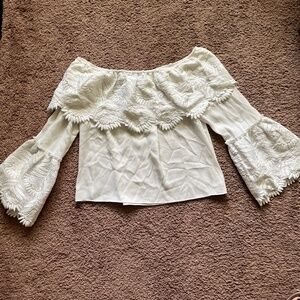 white ruffled bell sleeve off the shoulder blouse